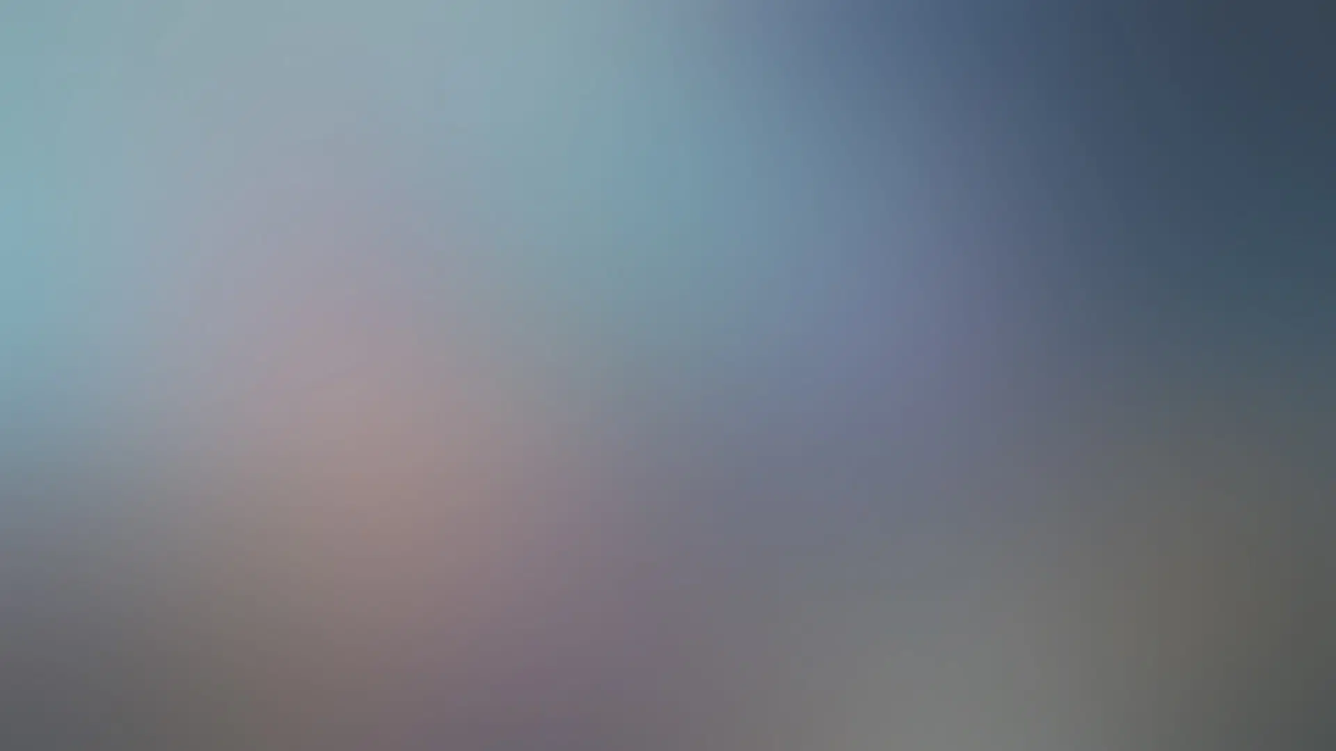 a color gradient background consisting of orange, pink, teal, purple, and teal hues.