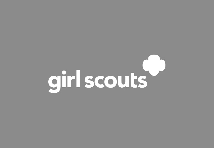girl scouts logo with white clover on grey background